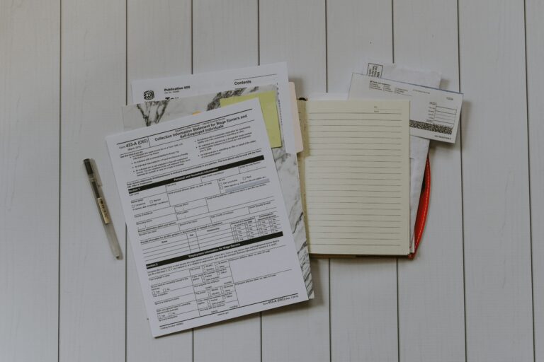A pile of tax documents with folders and papers scattered.