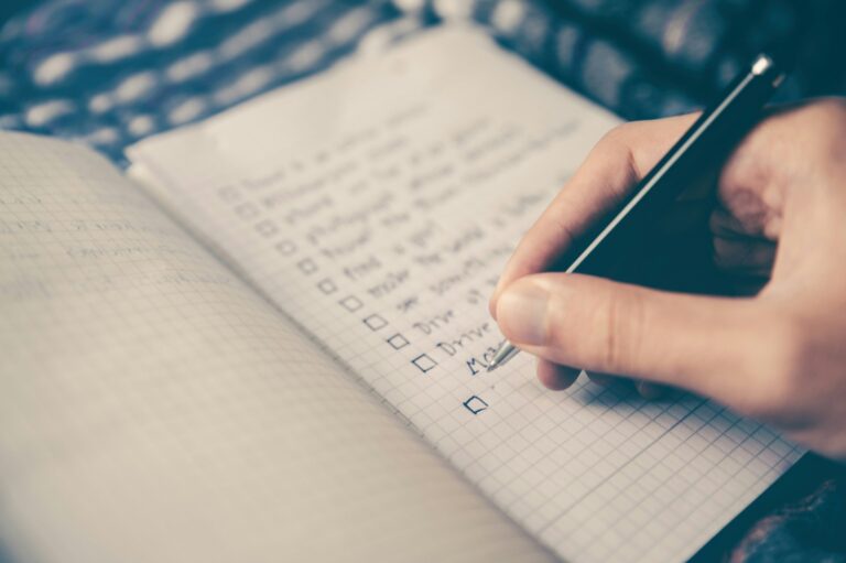 A person writing in a notebook.